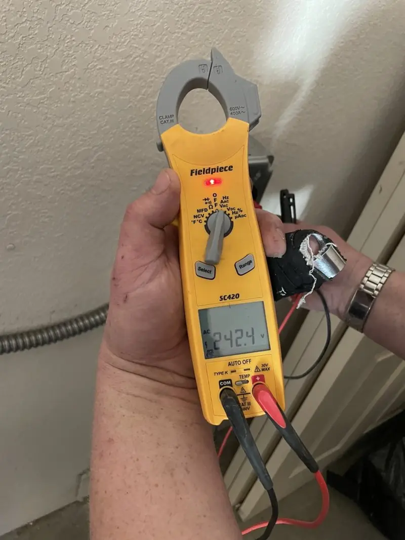 Voltage testing with clamp meter during Outlet Installation in Davenport